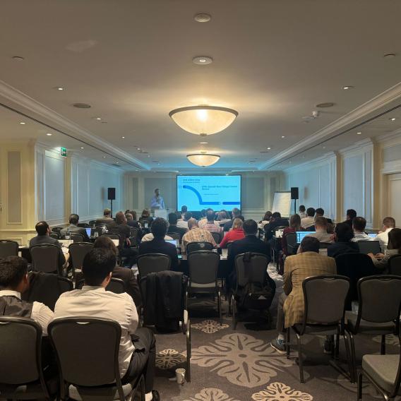 Shot of presentation from behind the meeting crowd